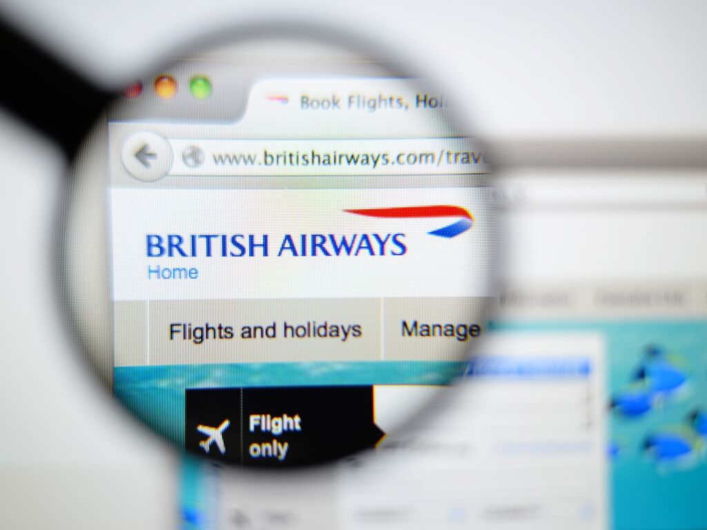 British Airways homepage on a monitor screen through a magnifying glass